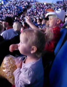 My view of the kids during most of the show: Allison eating popcorn, and Adam snapping pics!